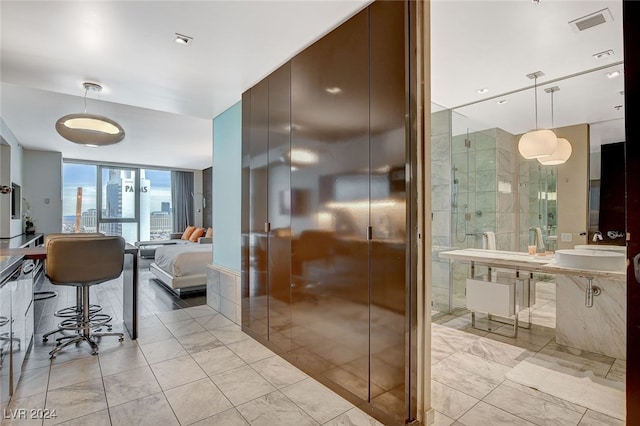 bathroom with floor to ceiling windows and sink