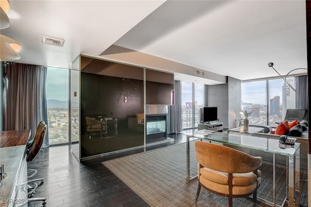 interior space with hardwood / wood-style floors, a wall of windows, and a healthy amount of sunlight