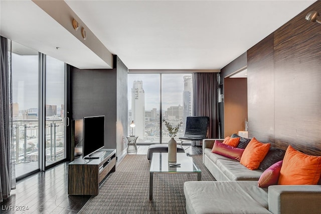 living room with floor to ceiling windows and a healthy amount of sunlight