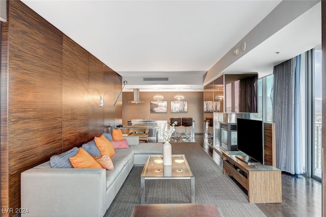 living room with a wealth of natural light and wooden walls