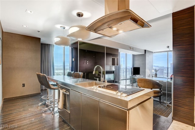 kitchen with dishwasher, sink, a wall of windows, electric cooktop, and island range hood