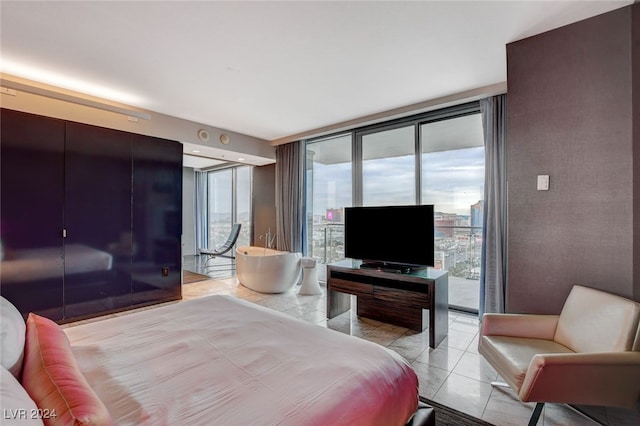 bedroom with floor to ceiling windows and light tile patterned flooring