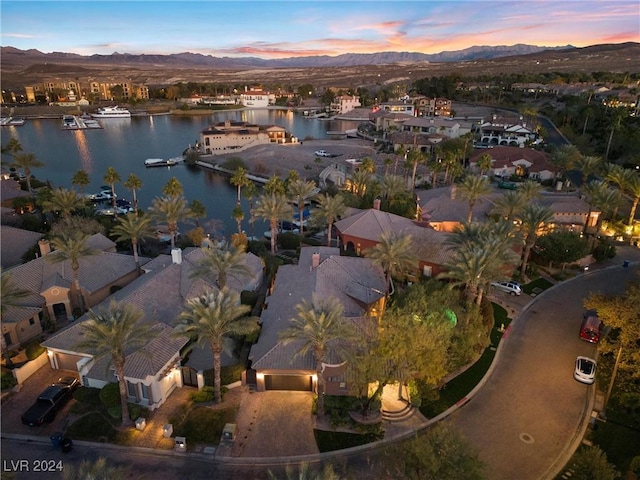 aerial view at dusk with a water and mountain view