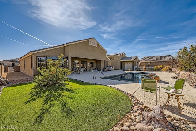 rear view of property featuring a yard and a patio