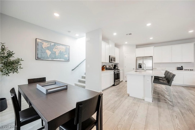 dining area featuring light hardwood / wood-style flooring and sink