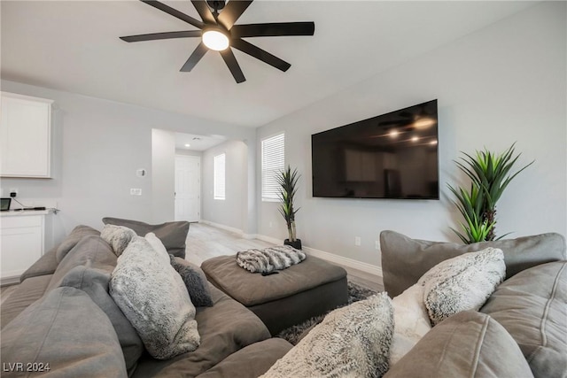 living room with ceiling fan and light hardwood / wood-style floors