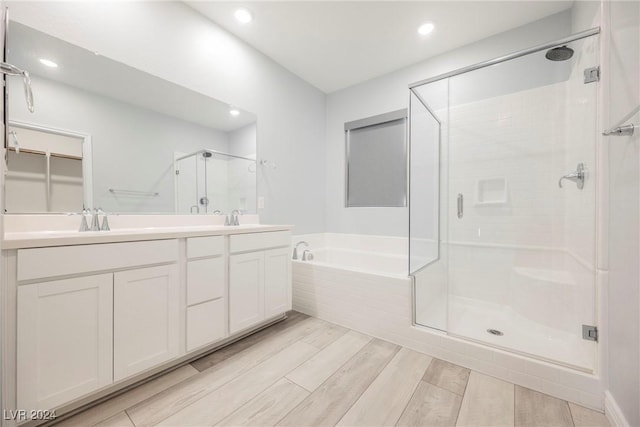 bathroom featuring independent shower and bath and vanity