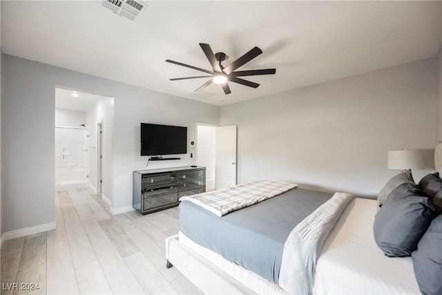 bedroom with connected bathroom, ceiling fan, and light hardwood / wood-style floors