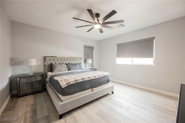 bedroom with ceiling fan and light hardwood / wood-style flooring