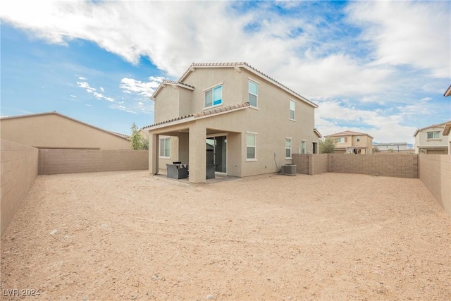 rear view of property with central AC and a patio area