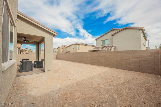 view of yard with a patio area and ceiling fan