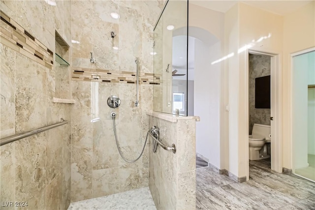 bathroom with toilet and walk in shower