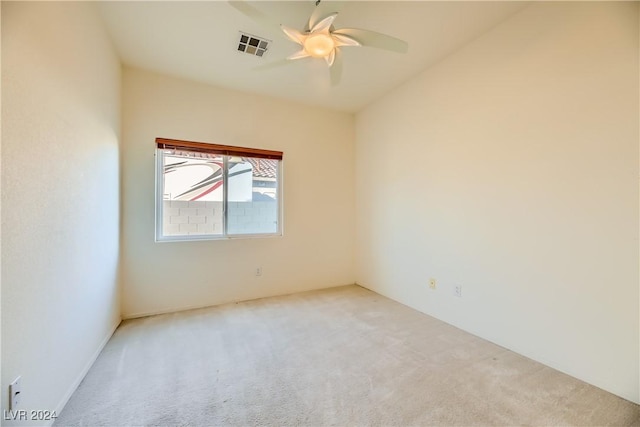 carpeted spare room with ceiling fan and visible vents