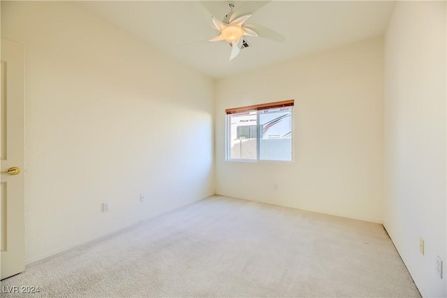 unfurnished room with light colored carpet and ceiling fan