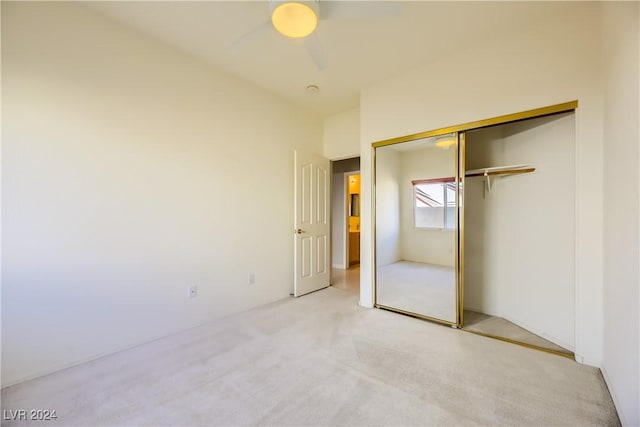 unfurnished bedroom featuring a closet, carpet flooring, and ceiling fan