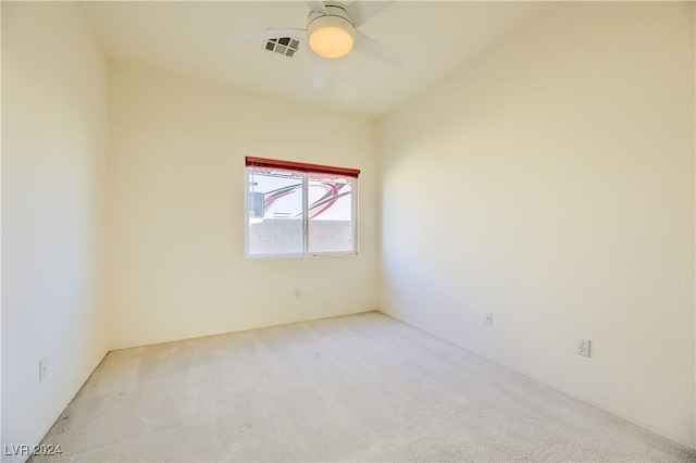 carpeted spare room featuring ceiling fan