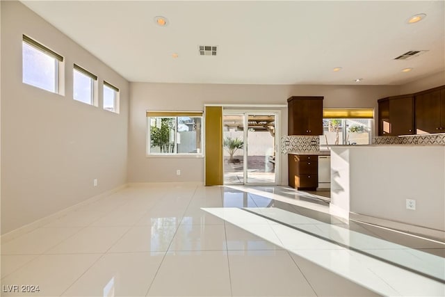 interior space with light tile patterned floors, plenty of natural light, visible vents, and recessed lighting