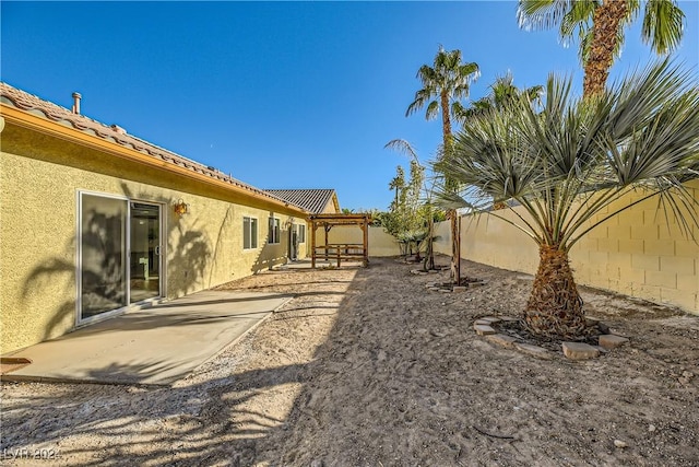 view of yard with fence and a patio