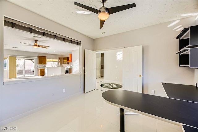 kitchen with wall chimney range hood and ceiling fan