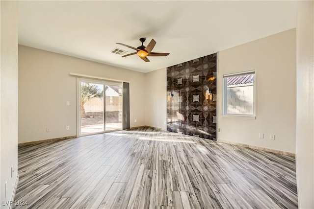 unfurnished living room featuring hardwood / wood-style floors and ceiling fan