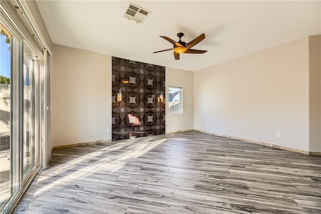 unfurnished living room with hardwood / wood-style flooring and ceiling fan