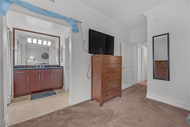 bedroom with sink, ornamental molding, and light carpet