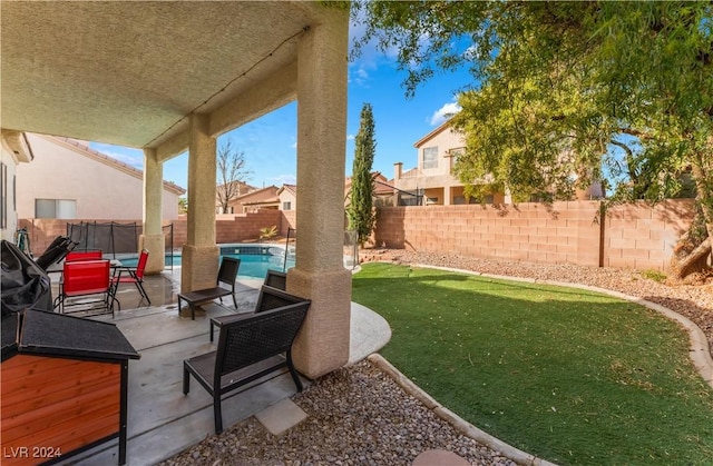 view of yard with a fenced in pool and a patio area