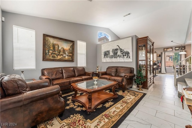 living room featuring a wealth of natural light and lofted ceiling