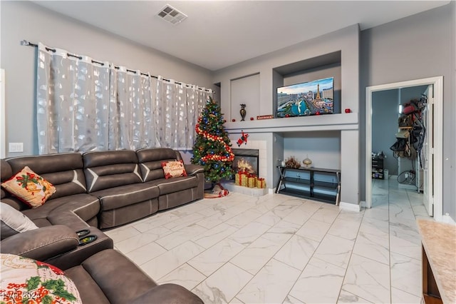 living room with a tiled fireplace