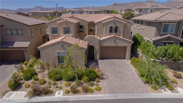 mediterranean / spanish home with a mountain view and a garage