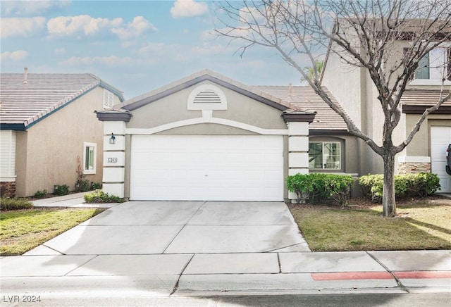 single story home with a front lawn and a garage