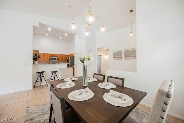 tiled dining space with radiator heating unit and high vaulted ceiling