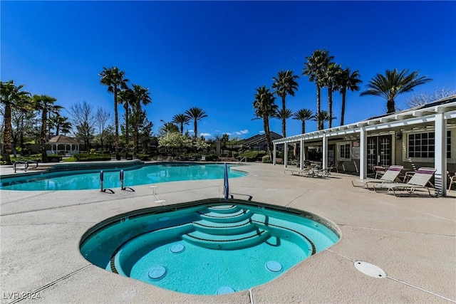 view of pool with a community hot tub and a patio area