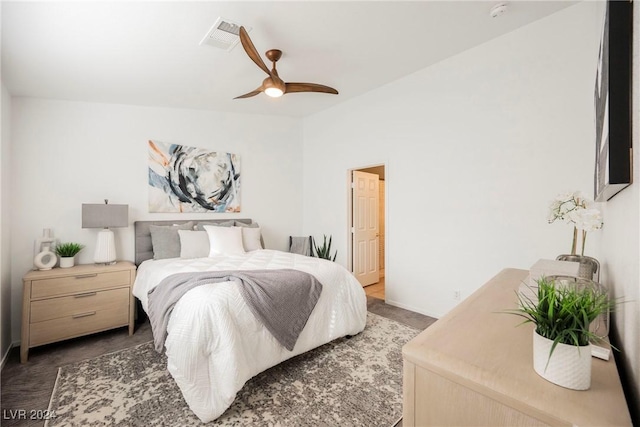 bedroom featuring ceiling fan and dark carpet