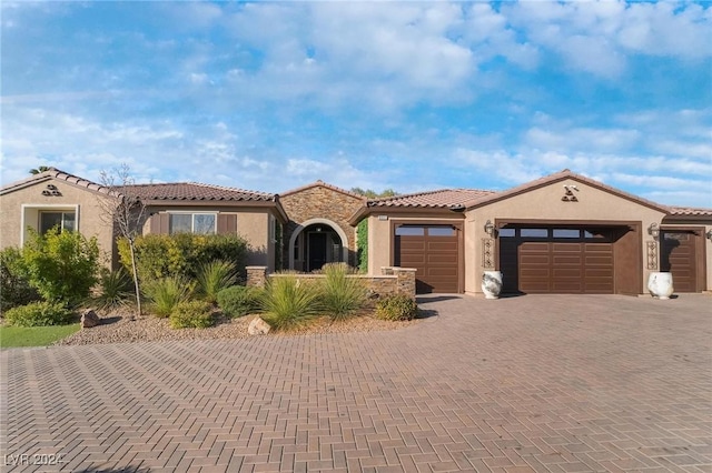 mediterranean / spanish house featuring a garage