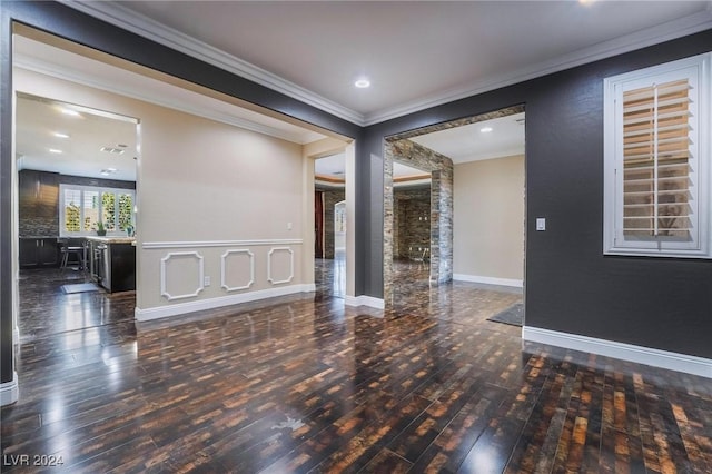 unfurnished room featuring dark wood-type flooring and ornamental molding