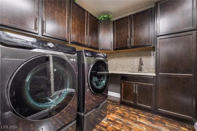 washroom featuring dark hardwood / wood-style floors, cabinets, separate washer and dryer, and sink