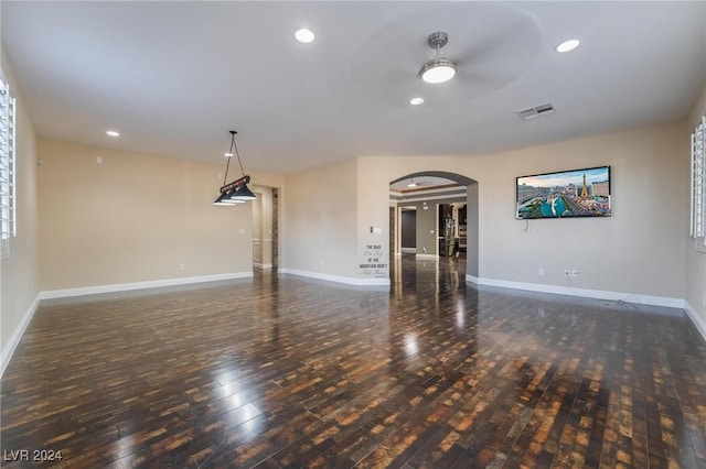 unfurnished room with dark hardwood / wood-style floors and ceiling fan