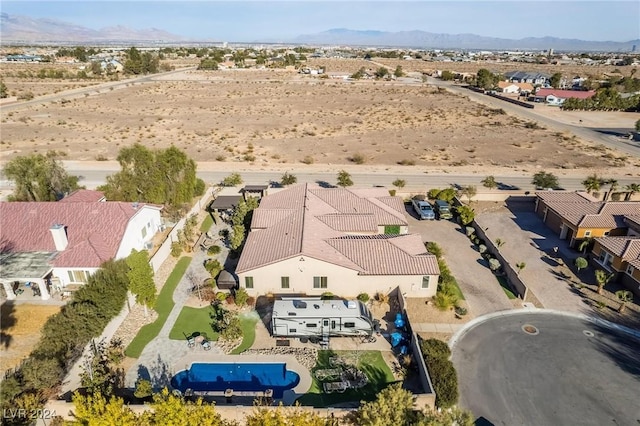 birds eye view of property with a mountain view