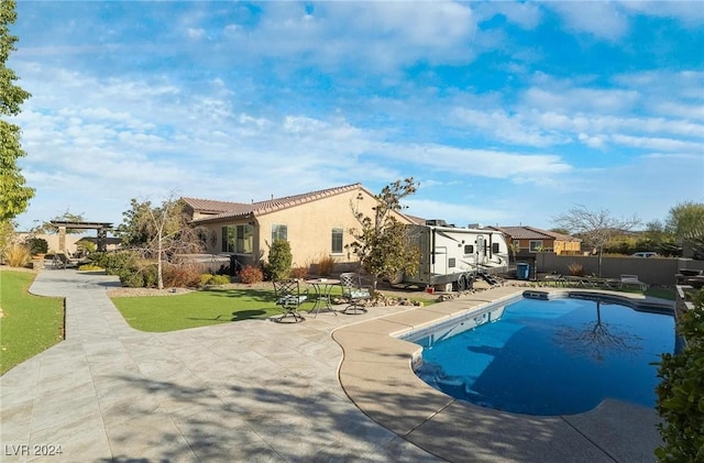 view of pool featuring a yard and a patio