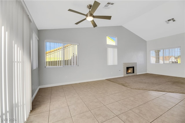 unfurnished living room with light tile patterned floors, vaulted ceiling, and ceiling fan