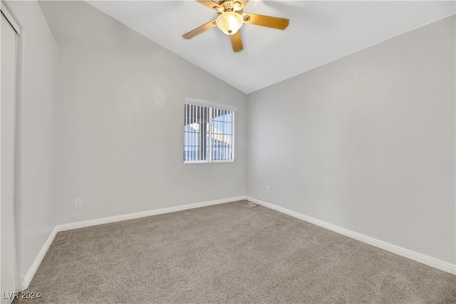 carpeted empty room with ceiling fan and vaulted ceiling