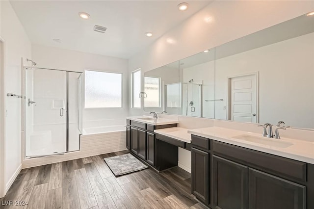 bathroom with separate shower and tub, hardwood / wood-style floors, and vanity