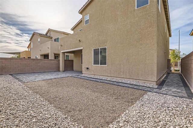 rear view of property featuring a patio area