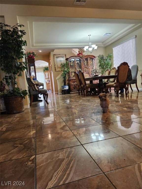 dining space featuring a healthy amount of sunlight and an inviting chandelier