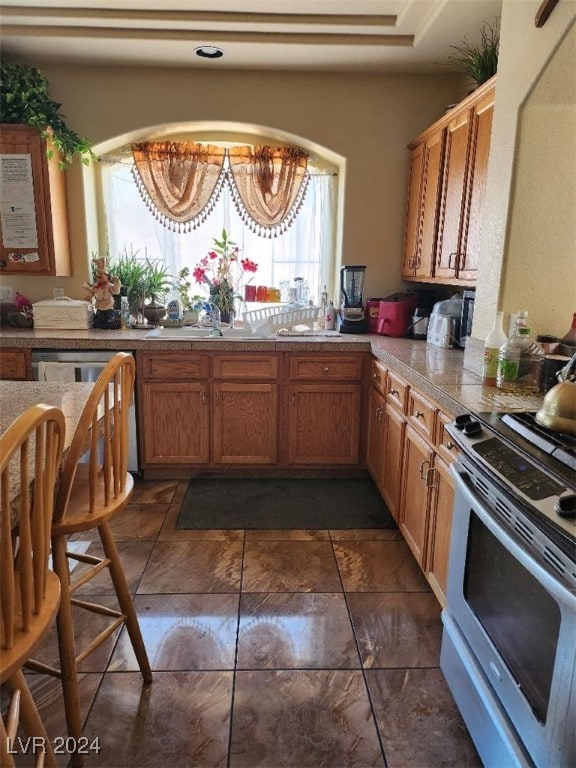 kitchen with dishwasher and white range with gas stovetop