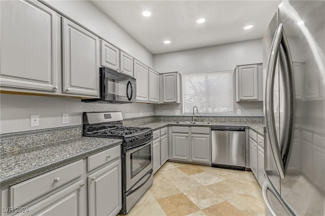 kitchen with gray cabinetry, sink, and appliances with stainless steel finishes