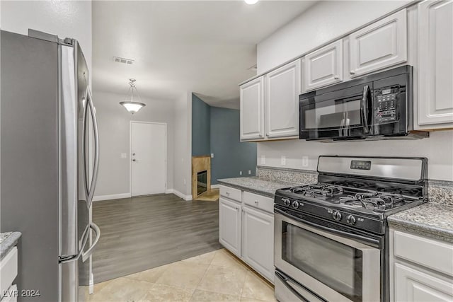 kitchen with white cabinets, pendant lighting, and appliances with stainless steel finishes