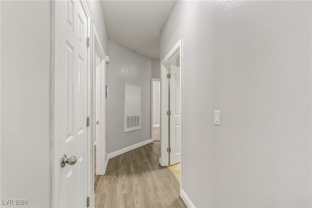 hallway with light hardwood / wood-style flooring