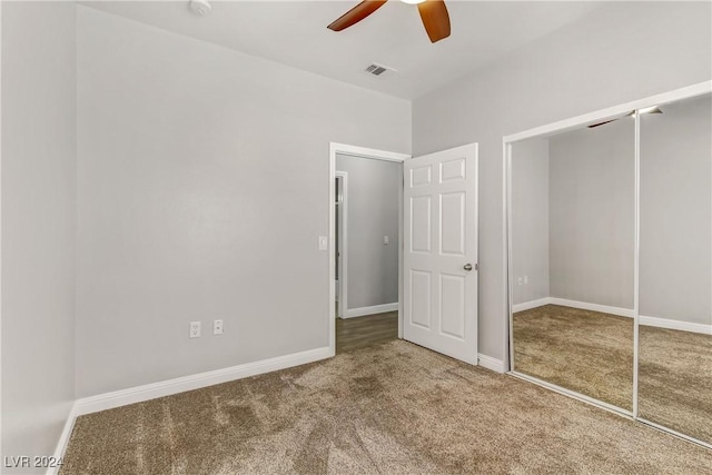 unfurnished bedroom featuring ceiling fan, a closet, and carpet floors